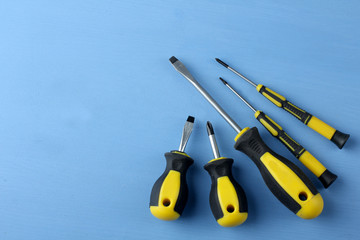 a new set of screwdrivers on a blue wooden background