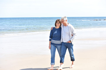 Senior couple walking on the beach