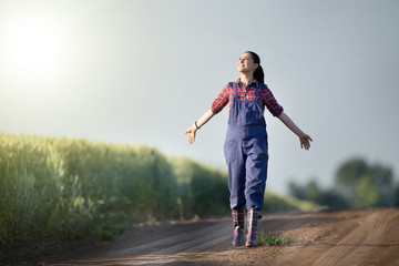 Happy farmer girl in wheat field