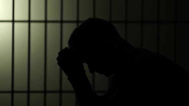 Silhouette of a man in prison