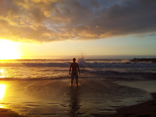 The man at sea. Sun dusk silhouette.