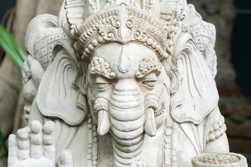 Old stone statue of Ganesha - a hindu symbol of luck in the jungle 
