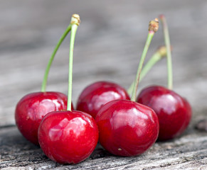 Fresh cherry berries on old wooden background.