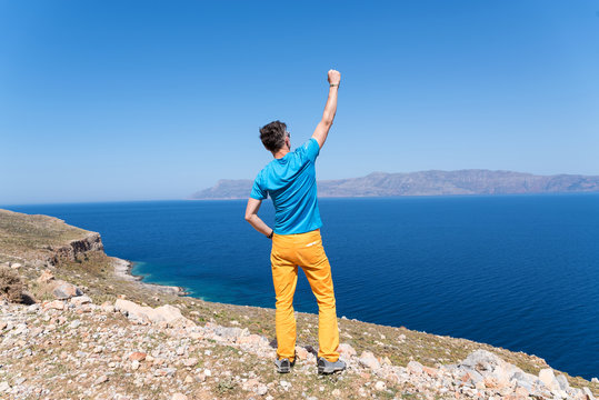 man enjoys his vacation in Greece near the sea 
