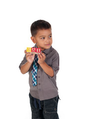 cute little boy showing his name on building blocks.