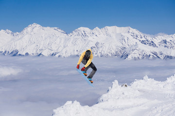 Snowboard rider jumping on mountains. Extreme snowboard freeride sport.