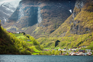 Settlement in narrow valley on the coast of norwegian fjord - obrazy, fototapety, plakaty