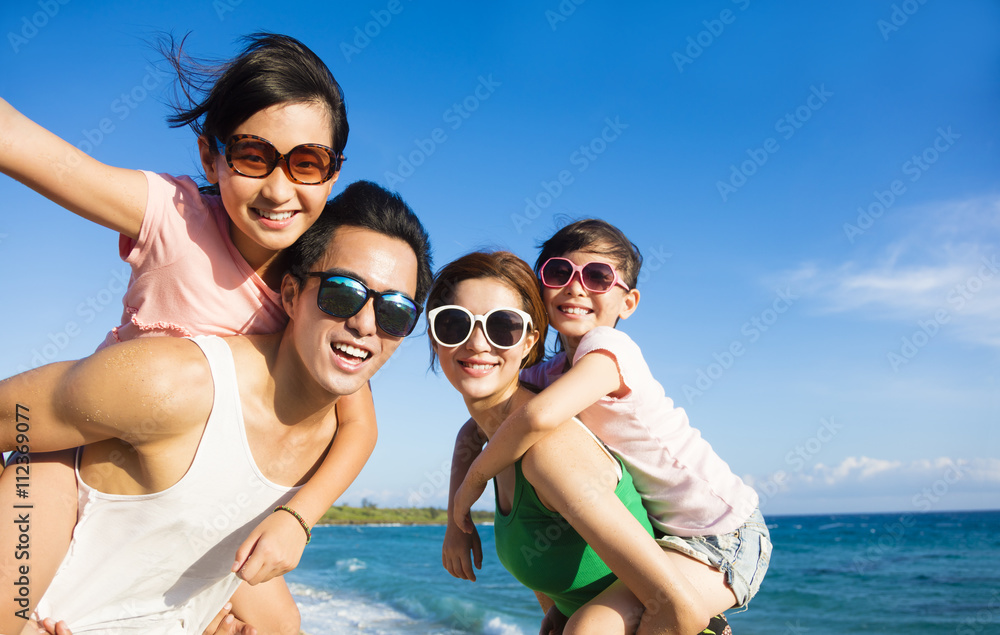 Wall mural happy family having fun at the beach