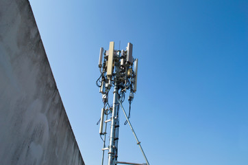High mast metal structure telecommunication on tower with blue sky.