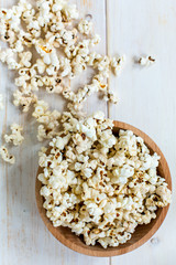 Popcorn in wooden bowl. View from above.