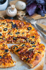 Piece of delicious pizza with sausage and cheese.