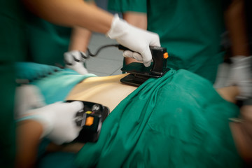 Defibrillator practice on a CPR with motion blur