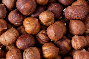 Raw unshelled hazelnuts background