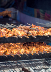 Street Food. Meat On Skewers Cooking Over Charcoal Grill