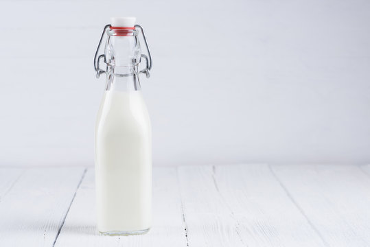 Bottle of milk on white wooden table