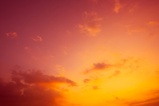 Colorful tropical sky with golden clouds at sunset time