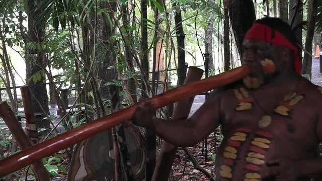 Yirrganydji Aboriginal man explains about the didgeridoo during a cultural show in Queensland, Australia