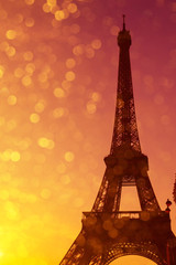 Eiffel Tower silhouette at sunset in Paris France with shiny golden bokeh lights sparkle double exposure effect
