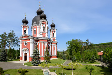Fototapeta na wymiar Orthodox Curchi monastery in Moldova with green trees and blue sky