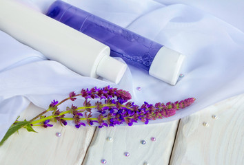 Face skin care cosmetic products - lotion and tonic in bottles, flowers, white cloths and beads on...