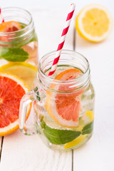 Homemade healthy smoothie with fresh fruits and ice in jar.