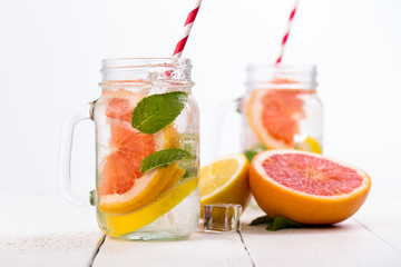 Homemade healthy smoothie with fresh fruits and ice in jar.