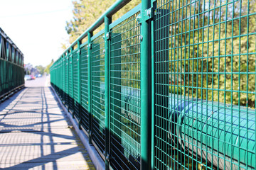 Detail of green railing at empty bridge