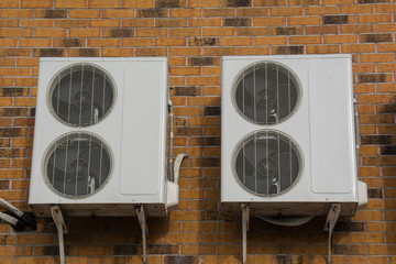 Twoair conditioning compressor on the brick wall