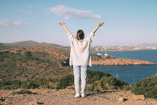 Traveler young woman stands on a cliff of cape Sounion and enjoy