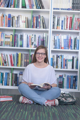 famale student reading book in library