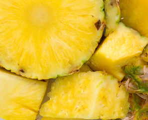 A fresh pineapple on a cutting board close view