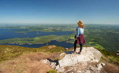 Viewing the vast green landscape of Ireland from the top of the mountain 