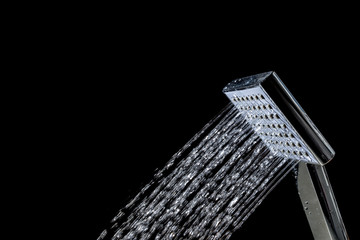 Shower with jets of water close up isolated on a black background
