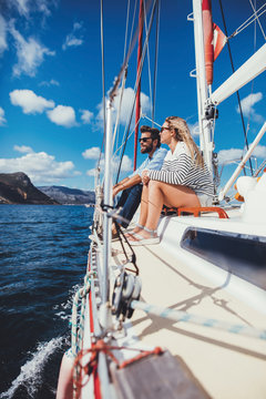 Couple  sitting together on the deck of a yacht
