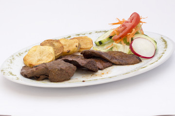 Peruvian Dish: anticuchos, grilled skewered beef heart meat, boiled potato.