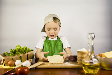 Boy preparing yeast dough for pizza