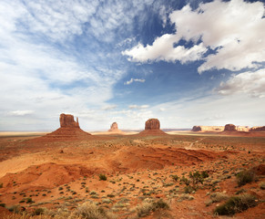 panoramic view of the monument valley under a cloudy sky