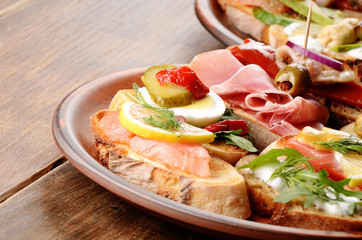 Open sandwiches with salmon, eggs, mussels, jamon and herring