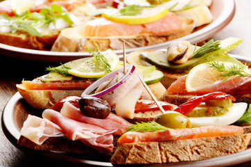 Open sandwiches with salmon, eggs, mussels, jamon and herring