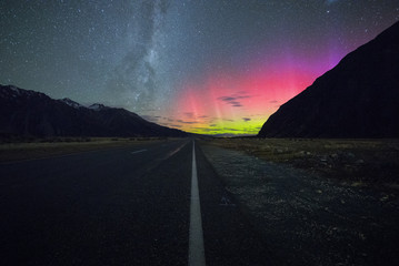 NEW ZEALAND 18TH APRIL 2015: Milky Way and Aurora Borealis in the middle of the road