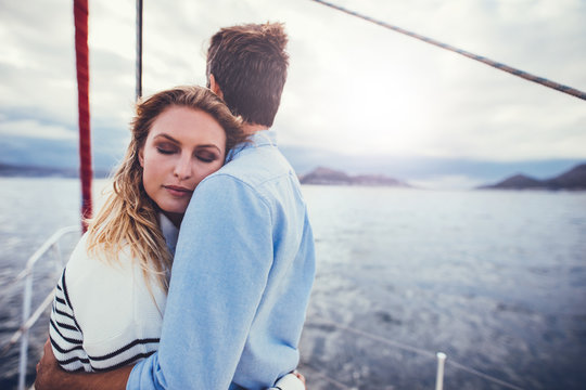 Affectionate couple in romantic getaway on a yacht