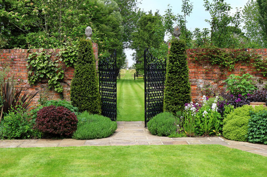 Gates through a walled English Landscaped Garden
