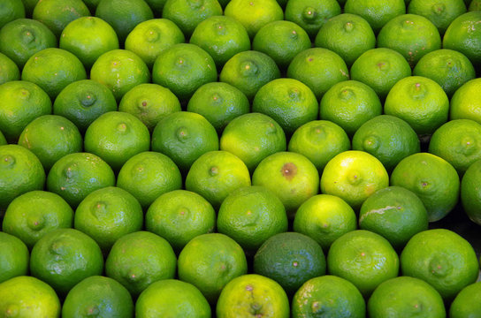 Detail of limes in rows displayed at market