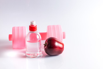 Fitness background with bottle of water ,dumbbell and apple