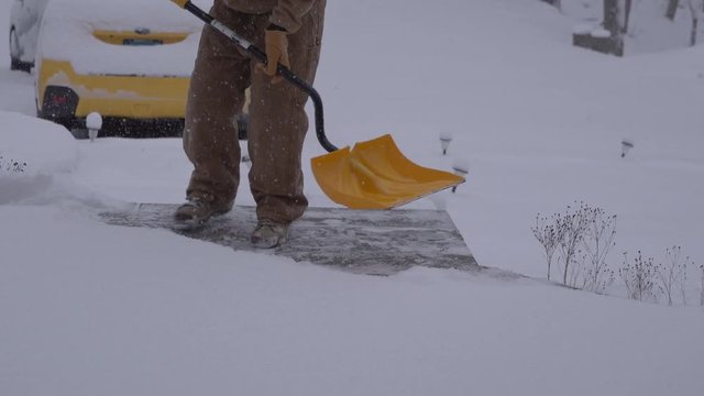 View Of A Man Shoveling Snow