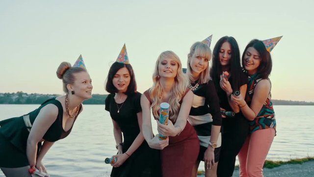 Drunk happy girl celebrating on the beach and fire crackers plan. Slow motion.