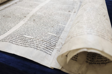 Torah on a dark-blue table.