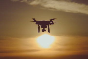 Silhouette drone / quadcopter at sunset
