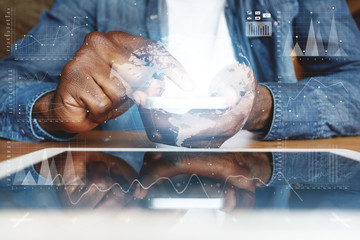 Visual effects. Graphic icons. People and future technology concept. Cropped shot of African American young man in denim jacket, touching electronic gadget with reflective touchscreen surface
