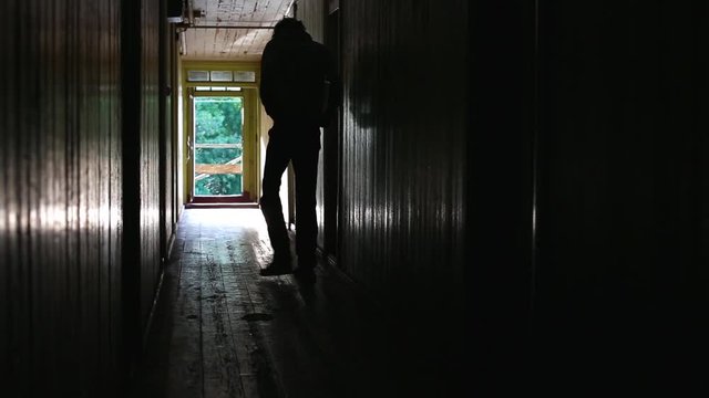 Depression sinks in for man in dark hallway